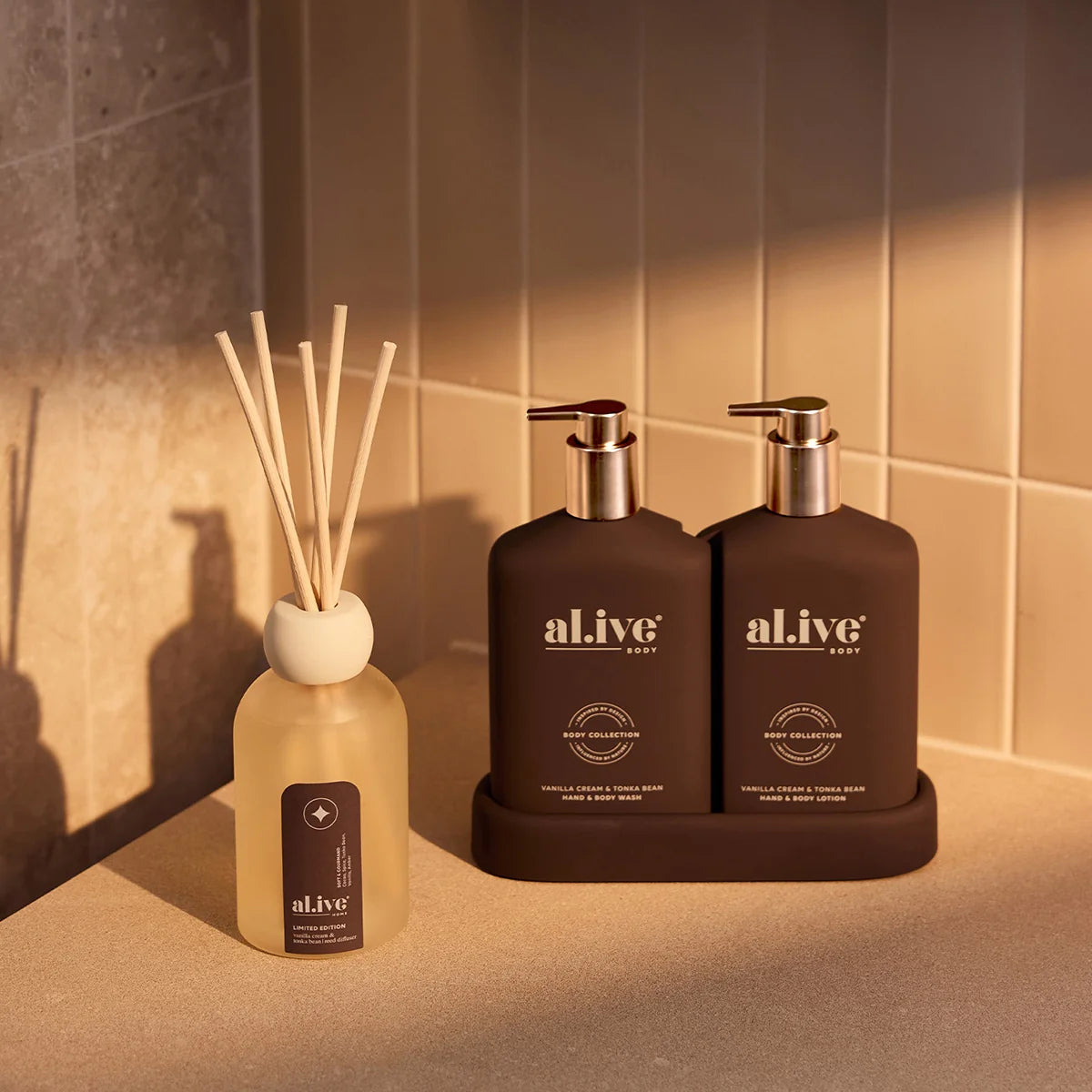 al.ive body Transformative Duo Vanilla Cream & Tonka Bean with reed diffuser in warm afternoon light