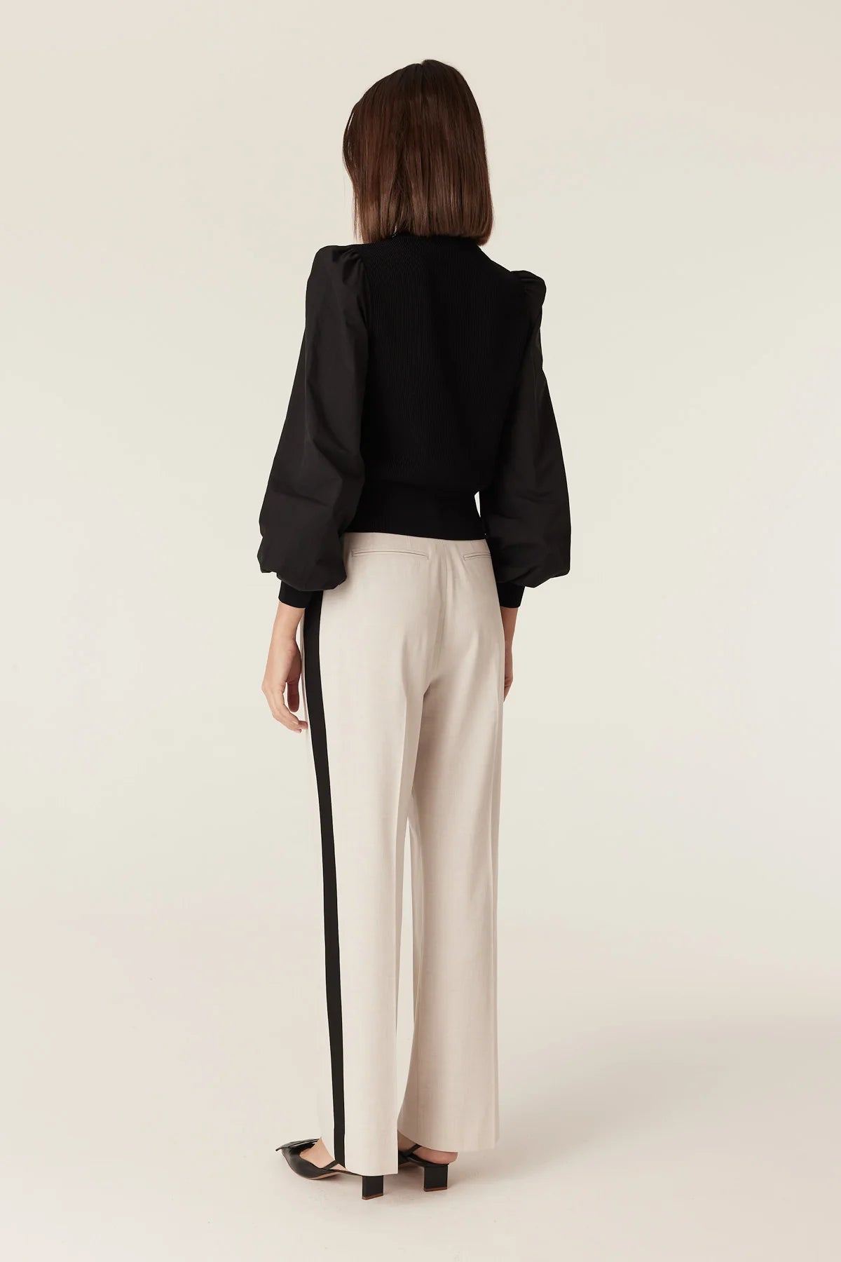 Back view of the Cable Melbourne Crepe Spring Cardigan in Black showing the puff sleeve silhouette