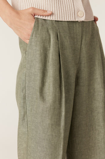 Close-up of the front pleat and waistband detail on the Cable Melbourne Evelyn Linen Pant in Green