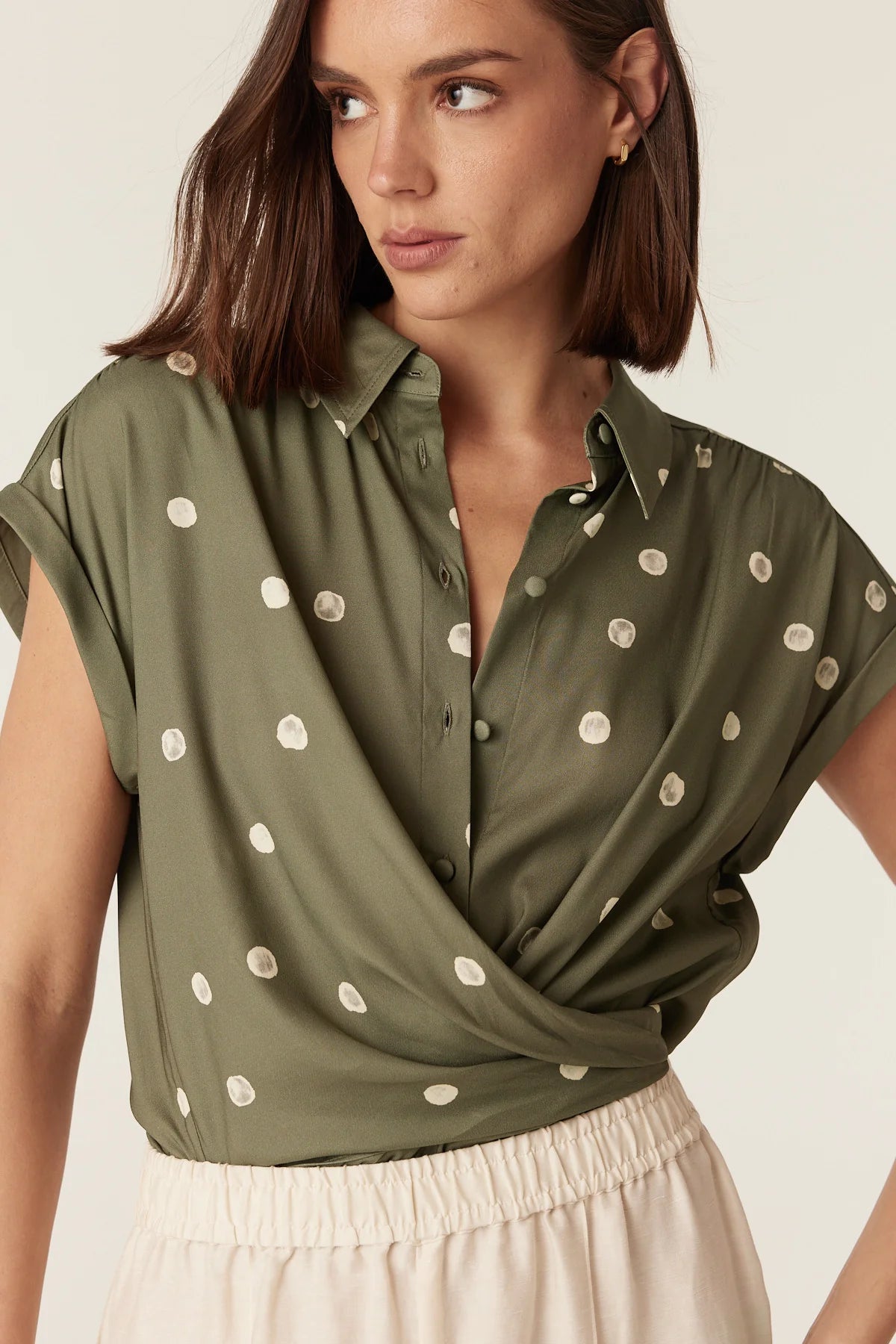 Close-up of the wrap and tie detail on the Cable Melbourne Muse Spring Blouse in Green Spot print