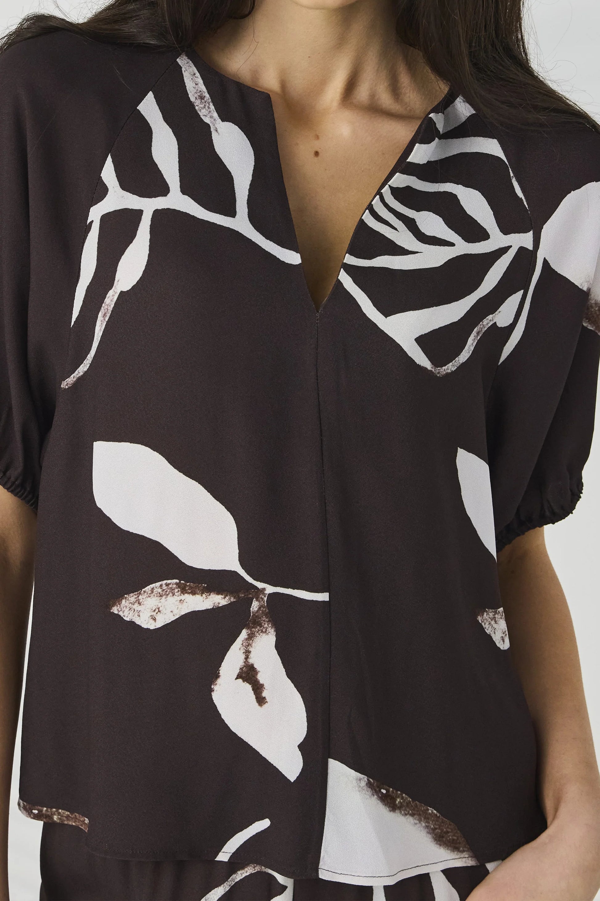 Close-up of the V-neckline on the Lania Maple Top in Maple Print viscose