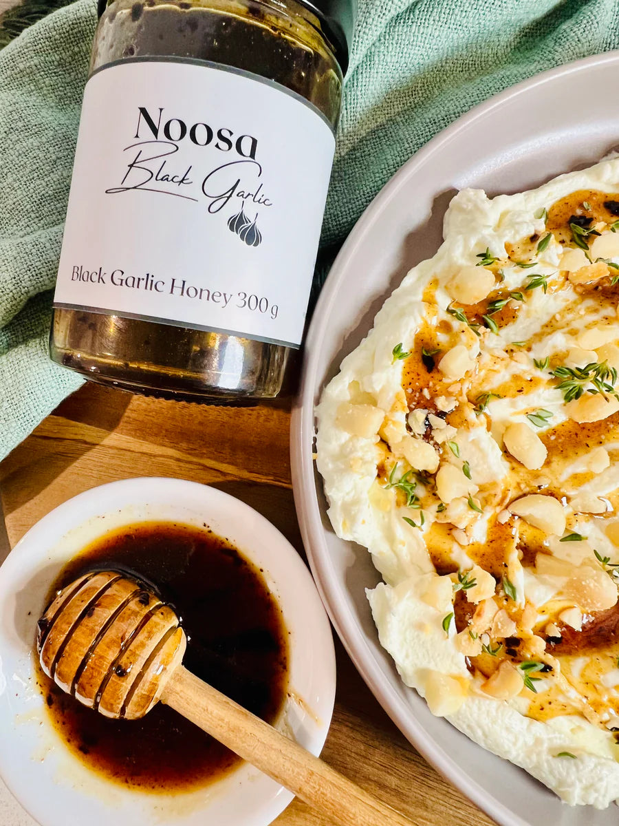 Noosa Black Garlic Honey drizzled over whipped feta with macadamias and thyme