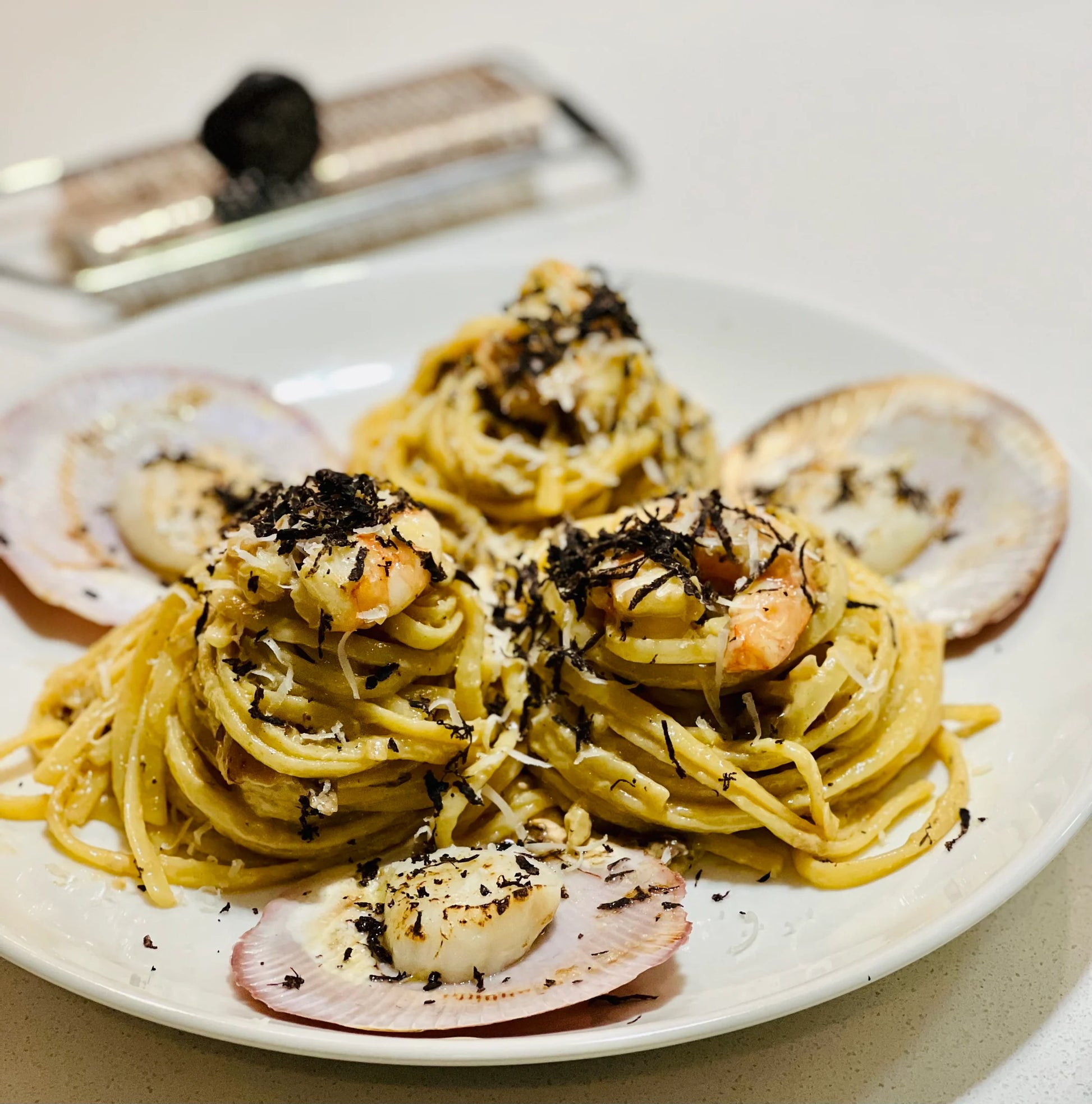 Scallop and prawn linguine finished with shaved Noosa Black Garlic
