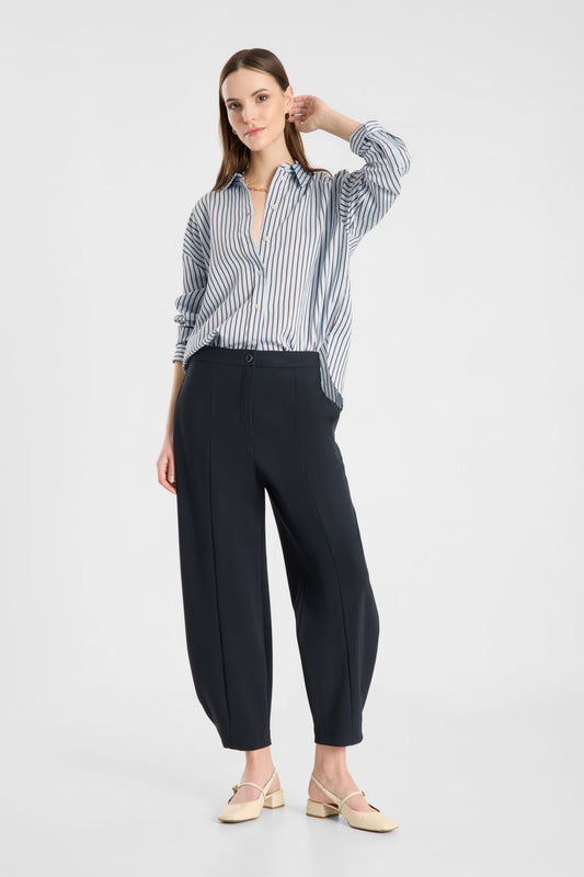 Model wearing Raffaello Rossi Odine Jersey Pant in Navy with a striped shirt, front view