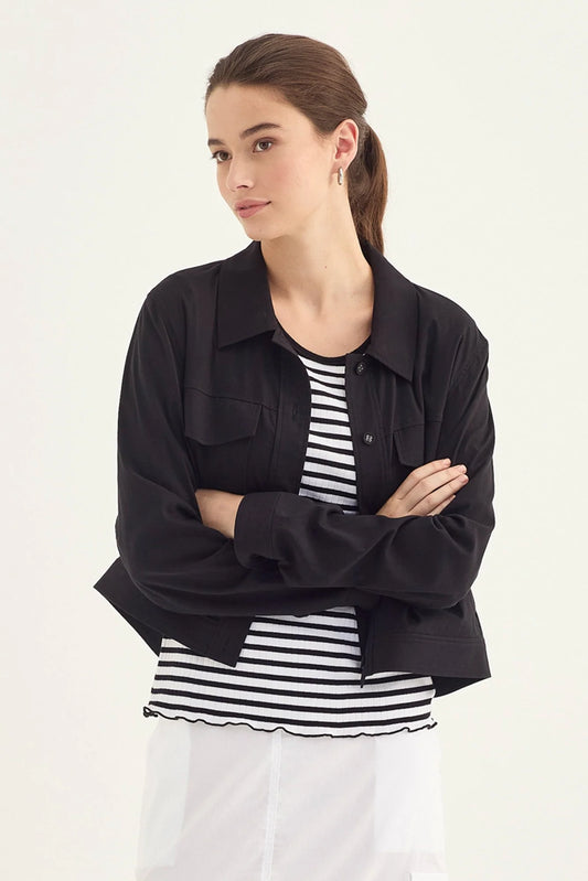 Verge Acrobat Icon Jacket in Black, worn - front styled with a striped tee and white skirt