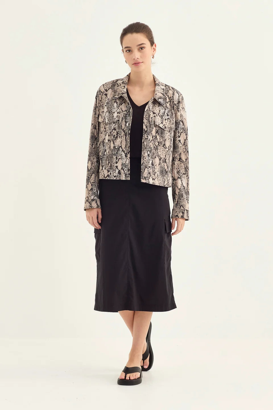 Verge Acrobat Serpent Jacket in Serpent Print, worn - front styled with a black midi skirt